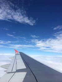 Cropped airplane flying against sky