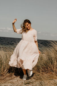 Full length of woman standing on beach