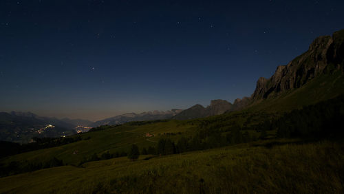 Scenic view of landscape against sky at night