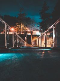 Illuminated bridge over water at night