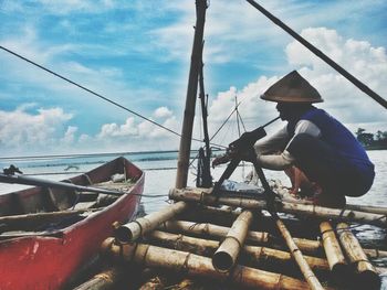 Sailboat in sea against sky