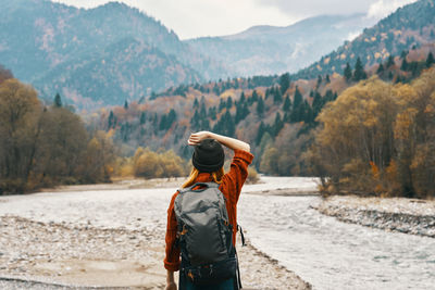 Rear view of man standing on mountain