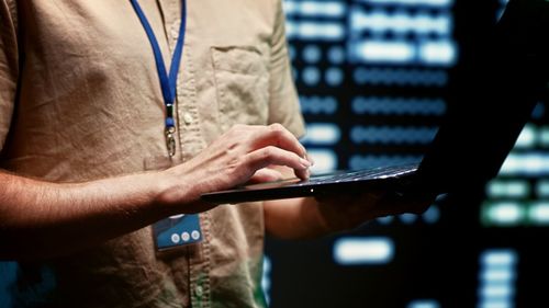 Midsection of man using digital tablet