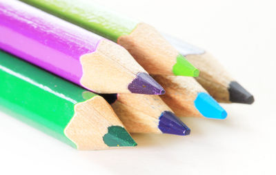 Close-up of multi colored pencils on table