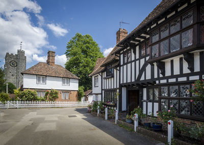 Tudor cottages and church tower in the village of chilham, kent, uk