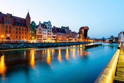 Gdansk night city riverside view. view on famous crane and facades of old gdansk city. poland.