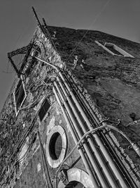 Low angle view of old building against sky in city