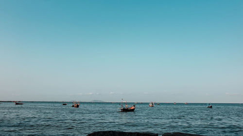 Sailboat in sea against clear sky