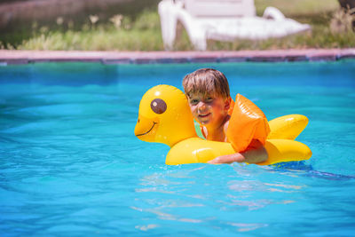 Portrait of boy swimming in pool