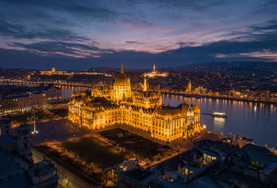 Night aerial shot of the hungarian parliament building and the danube river in budapest cityscape 