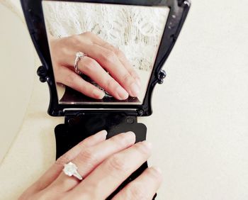 Close-up of woman hand reflection in mirror