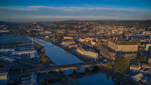 High angle view of river amidst buildings in city against sky