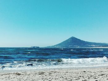 Scenic view of sea against clear blue sky