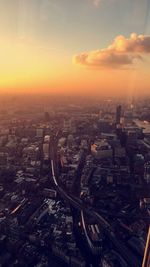 High angle view of illuminated cityscape against sky during sunset