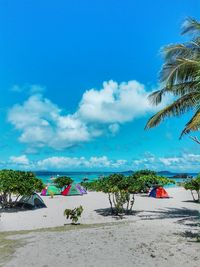 Scenic view of beach against blue sky