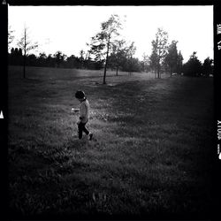 Full length of boy standing on grassy field