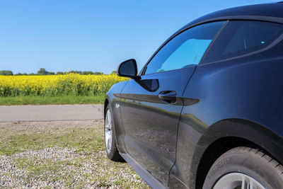 Car on field against clear sky