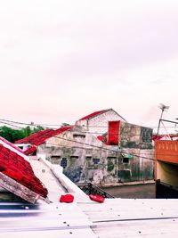 Houses by building against sky during winter