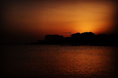 Scenic view of sea against orange sky