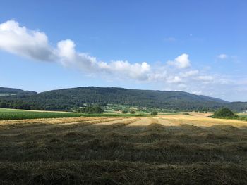 Scenic view of landscape against cloudy sky