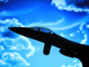 Low angle view of silhouette airplane against sky