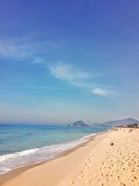 Scenic view of beach against blue sky