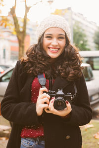 Portrait of smiling young woman wearing hat