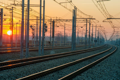 Train station with rails at sunset