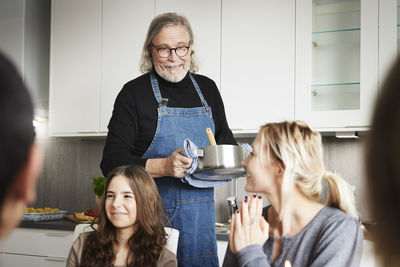 Man serving food to family