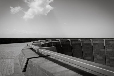 Railing by sea against sky