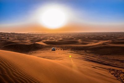 Scenic view of desert against sky during sunset