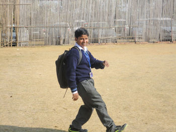 Side view of a young man running