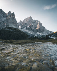 Scenic view of lake and snowcapped mountains against sky