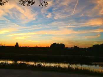 Scenic view of lake against orange sky