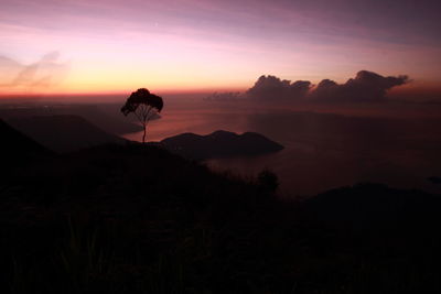 Scenic view of silhouette mountains against sky during sunset