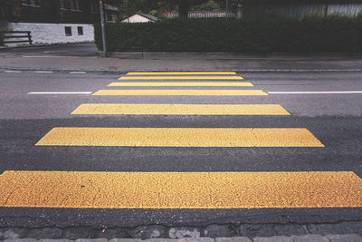 High angle view of yellow crossing sign on road