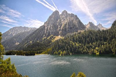 Scenic view of lake and mountains against sky