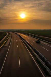 Aerial view of highway against sky during sunset