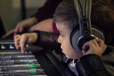 Cute boy mixing music in recording studio