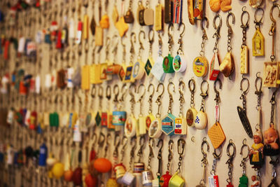 Full frame shot of multi colored key rings hanging on wall in store