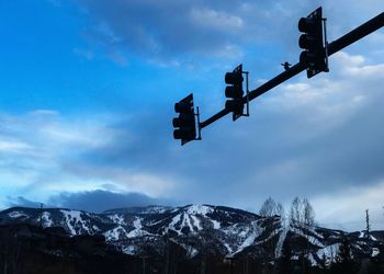 Low angle view of snow covered tree against sky