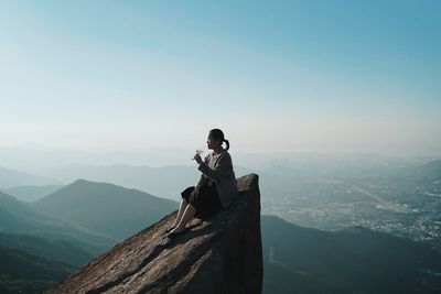Rear view of man looking at mountain landscape