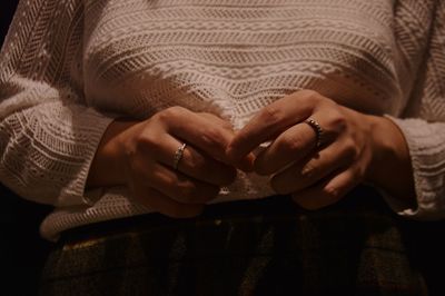 Midsection of woman sitting on sofa