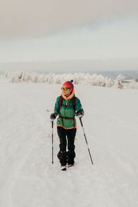 Girl skiing on snow covered field