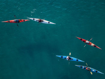 People flying over sea against sky