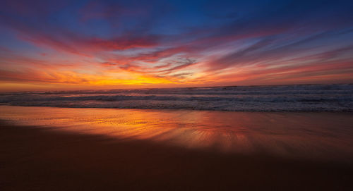 Scenic view of sea against romantic sky at sunset