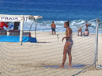 People on beach by sea