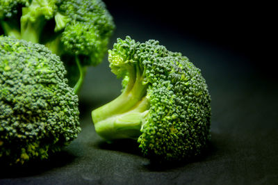 Close-up of broccoli on table against black background