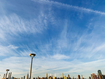 Low angle view of street and buildings against sky