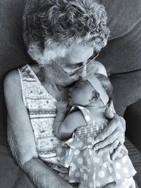 High angle view of grandmother kissing granddaughter